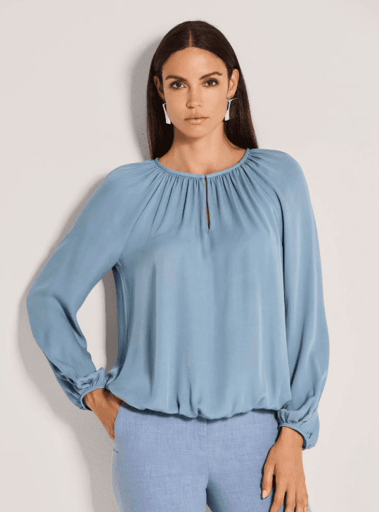 Blue satin blouse worn on model