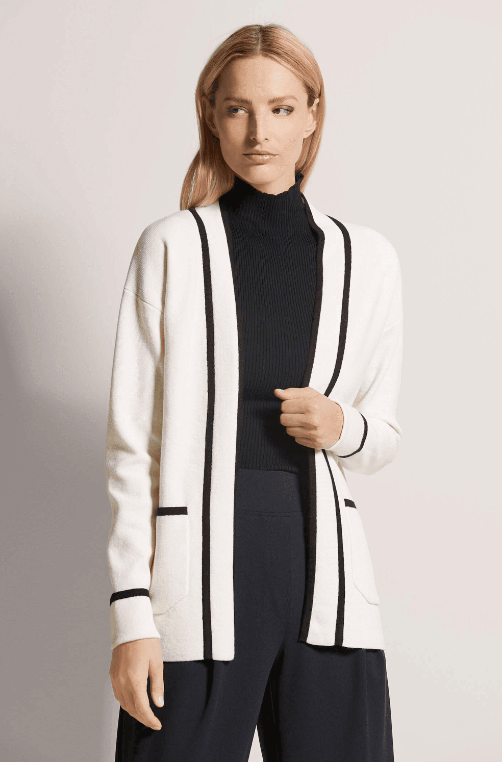 Cream cardigan with contrast trim worn on model